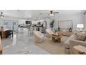 Spacious living room with an open-concept design that showcases a kitchen and dining area at 6370 Elmhurst Dr, Pinellas Park, FL 33782
