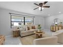 Inviting living room with a comfortable couch, large window, neutral color palette, and stylish decor at 6370 Elmhurst Dr, Pinellas Park, FL 33782