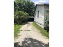 Exterior view of the driveway leading to detached garage at 6403 Elliot Dr, Tampa, FL 33615