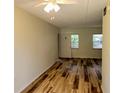 Cozy living room featuring wood-look flooring, neutral paint, and great natural light at 6925-A Avenue Des Palais # 1A, South Pasadena, FL 33707