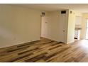 Bright living room featuring stylish wood-look flooring and neutral paint at 6925-A Avenue Des Palais # 1A, South Pasadena, FL 33707