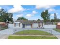 Landscaped front yard and driveway leading up to a charming, single-story home at 7107 Limestone Ln, Tampa, FL 33619