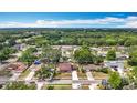 Scenic aerial view of a residential neighborhood nestled among lush trees and a serene lake at 7206 Timber Ct, Tampa, FL 33625
