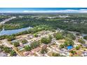 Scenic aerial view of a residential neighborhood nestled among lush trees and a serene lake at 7206 Timber Ct, Tampa, FL 33625
