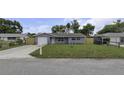 Exterior of a single-story house with a well-kept lawn and an attached garage at 7625 Marechal Ave, Port Richey, FL 34668