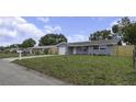 Inviting one-story home featuring a well-kept lawn and a convenient one-car garage at 7625 Marechal Ave, Port Richey, FL 34668