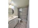 Bathroom featuring a glass-enclosed shower with decorative tile accents and a vanity sink at 8300 Bardmoor Blvd # 110, Seminole, FL 33777