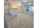Spacious kitchen featuring light wood cabinets, tile backsplash, and a full-size refrigerator at 8300 Bardmoor Blvd # 110, Seminole, FL 33777