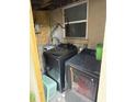 Functional laundry area featuring a washer and dryer, and storage at 8606 N 9Th St, Tampa, FL 33604