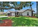 Well-manicured lawn and landscaping highlight this home's neutral paint and trim at 916 48Th Street E Dr, Bradenton, FL 34208