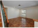 Bright living room with terracotta tile flooring and natural light from the window at 945 Hamilton Ct, Palm Harbor, FL 34683
