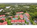Aerial view of condo community and lush landscaping with a community pool at 9481 Highland Oak Dr # 212, Tampa, FL 33647