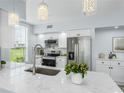 Contemporary kitchen featuring stainless steel appliances, marble countertops, and a stylish faucet and fixtures at 10520 White Lake Ct # 10520, Tampa, FL 33626