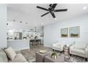 Bright living room featuring modern furnishings, stylish decor, and an open concept design to the dining area at 10520 White Lake Ct # 10520, Tampa, FL 33626