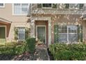 Close-up of a charming townhome entrance with lush greenery and a welcoming front door at 12228 Foxmoor Peak Dr, Riverview, FL 33579