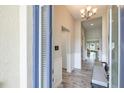Entryway with wood-look tile flooring, wainscoting, a bench, and views into the living spaces at 12652 Shetland Walk Dr, Lithia, FL 33547
