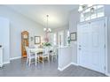 Inviting dining room with wood-look tile floors, bright natural light, and stylish chandelier at 13602 Fawn Ridge Blvd, Tampa, FL 33626