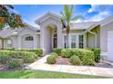 Charming home featuring a beautifully landscaped yard and inviting stone pathway leading to the front door at 13602 Fawn Ridge Blvd, Tampa, FL 33626