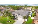 Stunning aerial shot of a single-story home in a lush neighborhood with well-maintained landscaping at 1631 Shady Oaks Dr, Oldsmar, FL 34677
