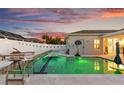 Beautiful backyard pool with deck chairs, and a unique lighting and an adjacent privacy fence at 1631 Shady Oaks Dr, Oldsmar, FL 34677