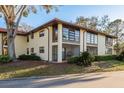 Exterior view featuring the screened-in porch and large windows at 1712 Hammock Pine Blvd # 1712, Clearwater, FL 33761