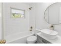 Beautiful bathroom featuring modern fixtures, a stylish vanity, and a shower-tub combo at 1843 Berg Rd, Holiday, FL 34690