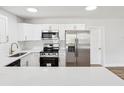 Modern kitchen with stainless steel appliances, quartz countertops, and white subway tile backsplash at 1843 Berg Rd, Holiday, FL 34690
