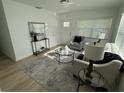 Bright living room with neutral furniture, wood-look flooring, and stylish decor at 1913 W Saint Conrad St, Tampa, FL 33607
