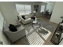 Sun-filled living room with sleek flooring, contemporary decor, and neutral-toned furnishings at 1913 W Saint Conrad St, Tampa, FL 33607