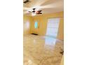Cozy living room featuring contemporary flooring, ceiling fan and natural light at 1918 Crown Park Dr, Valrico, FL 33594
