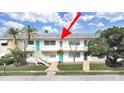 View of building exterior featuring bright teal doors, steps, and tropical foliage at 1921 58Th N Ave # 15, St Petersburg, FL 33714
