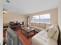 Inviting living room with hardwood floors, cream-colored sofa, and bright windows at 1921 58Th N Ave # 15, St Petersburg, FL 33714