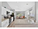 Bright kitchen with granite countertops, modern appliances, and a cozy breakfast nook area at 2527 Butterfly Landing Dr, Land O Lakes, FL 34638