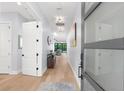 Inviting foyer featuring a light-filled hallway, light hardwood floors, and modern décor at 2707 Ridgewood Ave, Tampa, FL 33602