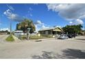 Street view showcasing a charming home, mature landscaping, and neighborhood surroundings at 3009 N 13Th St, Tampa, FL 33605