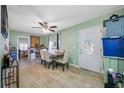Inviting dining room with tiled floors, ceiling fan, and a table set for six, perfect for Gathering gatherings at 317 Elizabeth Ave, Clearwater, FL 33759