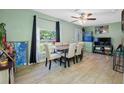 The dining room has tiled floors, neutral paint, large windows, and a table set for six with decor at 317 Elizabeth Ave, Clearwater, FL 33759