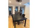 A black dining table with hardwood floors adjoins the open-concept kitchen at 4106 N Central Ave, Tampa, FL 33603