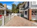 Spacious brick paver driveway leading to a charming two-story home with a well-maintained yard at 4106 N Central Ave, Tampa, FL 33603