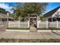 Charming home with white picket fence, lush landscaping, and inviting front porch detail at 4106 N Central Ave, Tampa, FL 33603