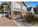 Beautiful two-story home with a welcoming front porch, white pillars, and ample windows for natural light at 4106 N Central Ave, Tampa, FL 33603