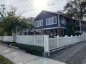 Charming two-story home with brick columns, white picket fence and mature landscaping at 4106 N Central Ave, Tampa, FL 33603