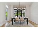 Charming dining room with modern chandelier and a large window with patterned shades at 4109 W Inman Ave, Tampa, FL 33609