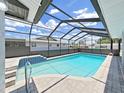 Beautiful screened-in pool featuring cool blue water and a patio with tile accents at 4652 Swallowtail Dr, New Port Richey, FL 34653