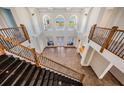 Grand foyer with soaring ceilings, black granite stairs, wrought iron railings, and arched windows at 4710 Troydale Rd, Tampa, FL 33615