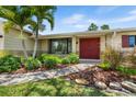 Inviting entrance of a home showcasing lush landscaping, with a well-maintained walkway leading to double doors at 4739 114Th N St, St Petersburg, FL 33708