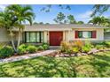 Beautiful home featuring a charming front garden and double front doors, inviting warmth and curb appeal at 4739 114Th N St, St Petersburg, FL 33708