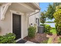 Charming front entrance with a black door and well-maintained landscaping and visible house numbers at 4743 Somerset Hill Ln, Riverview, FL 33578
