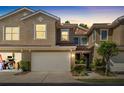 Two-story townhome at sunset with an attached garage and cozy entrance at 4920 Anniston Cir, Tampa, FL 33647