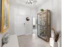 Inviting foyer featuring neutral tones, tile flooring, and display case for collectables at 537 Ocean Spray Dr, Ruskin, FL 33570